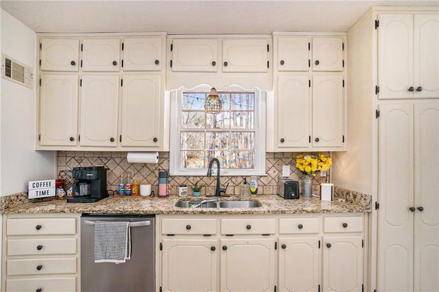 kitchen featuring dishwasher, white cabinets, visible vents, and a sink