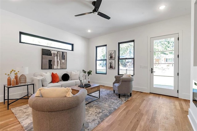 living area featuring recessed lighting, light wood-style flooring, and baseboards