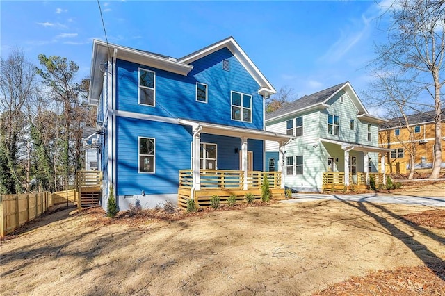 view of front of property with fence and covered porch