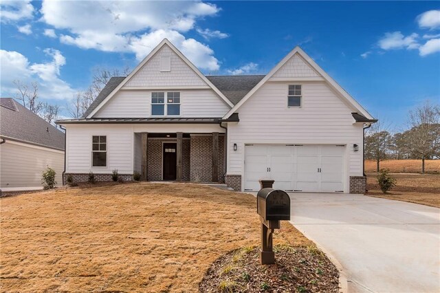5808 Swinging Gate Rd, Gainesville, GA 30506 - view of front facade featuring a garage, a standing seam roof, driveway, and brick siding