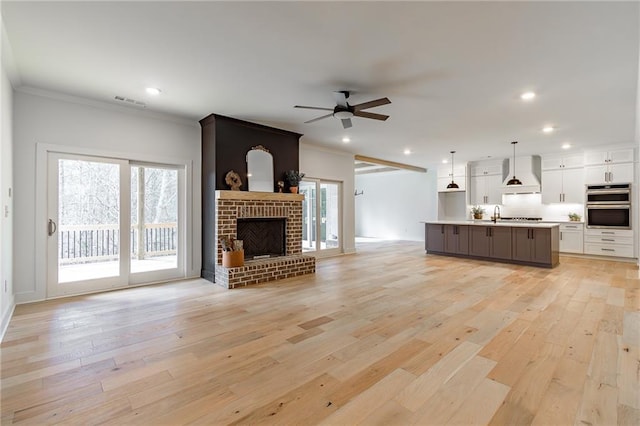 5808 Swinging Gate Rd, Gainesville, GA 30506 - unfurnished living room featuring crown molding, recessed lighting, and plenty of natural light
