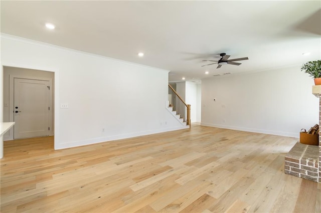 5808 Swinging Gate Rd, Gainesville, GA 30506 - unfurnished living room with crown molding, ceiling fan, light wood finished floors, and stairway