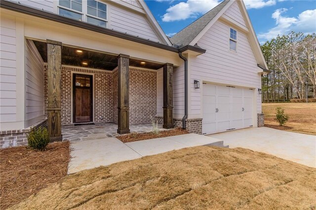 5808 Swinging Gate Rd, Gainesville, GA 30506 - exterior space featuring brick siding, an attached garage, covered porch, and concrete driveway