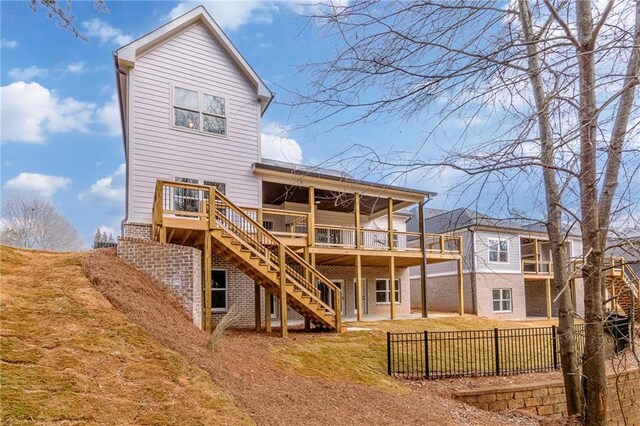 5808 Swinging Gate Rd, Gainesville, GA 30506 - rear view of house featuring fence, stairs, brick siding, a wooden deck, and a yard
