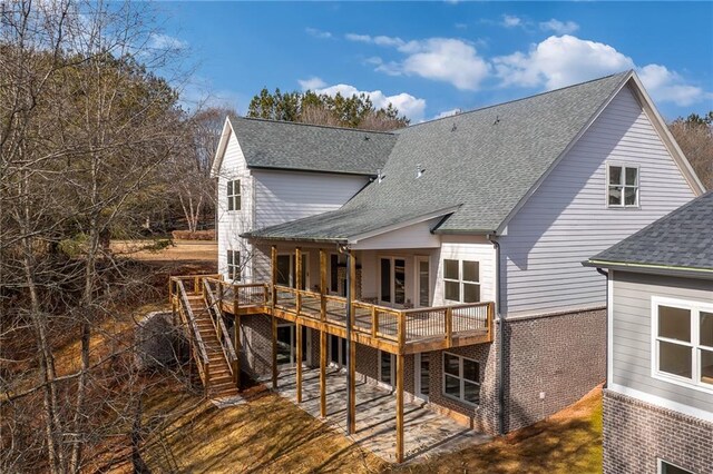 5808 Swinging Gate Rd, Gainesville, GA 30506 - back of property with stairs, a shingled roof, a deck, and brick siding