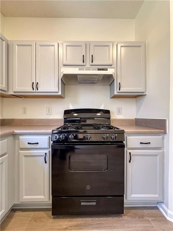 kitchen with white cabinets, black range with gas stovetop, and light wood-type flooring