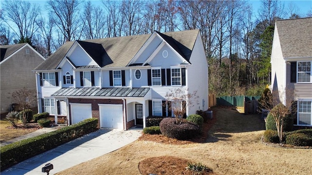 view of front of home featuring cooling unit and a garage