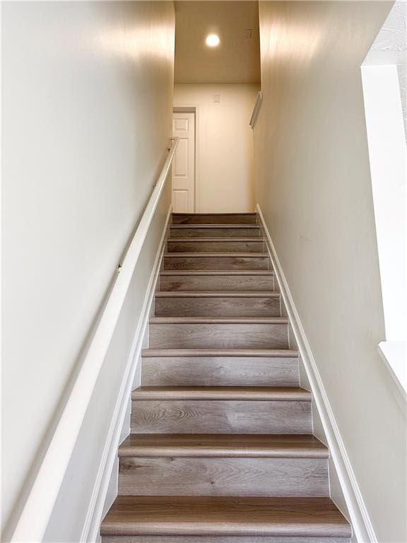 stairway featuring wood-type flooring