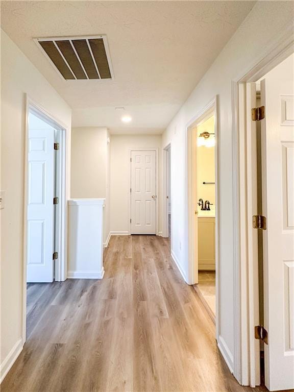 hallway featuring light hardwood / wood-style flooring