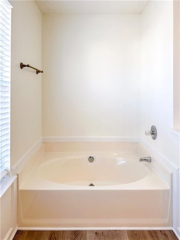 bathroom featuring a washtub and wood-type flooring