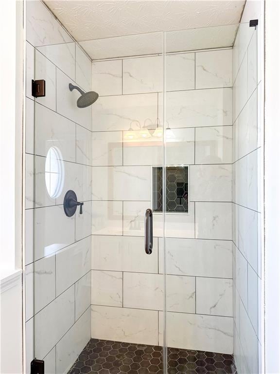 bathroom with a shower with door