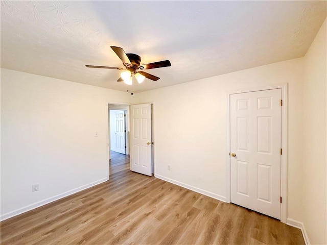 unfurnished bedroom featuring light wood-type flooring and ceiling fan