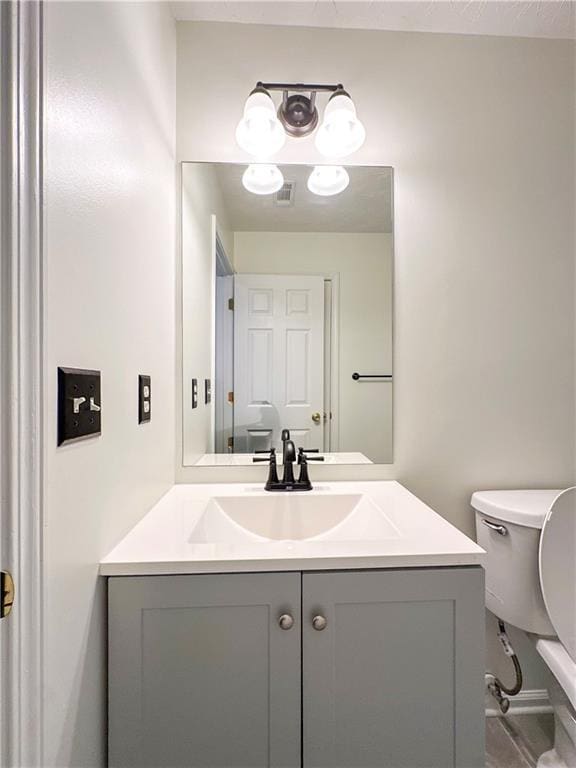 bathroom with vanity and toilet