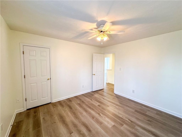 empty room featuring hardwood / wood-style flooring and ceiling fan