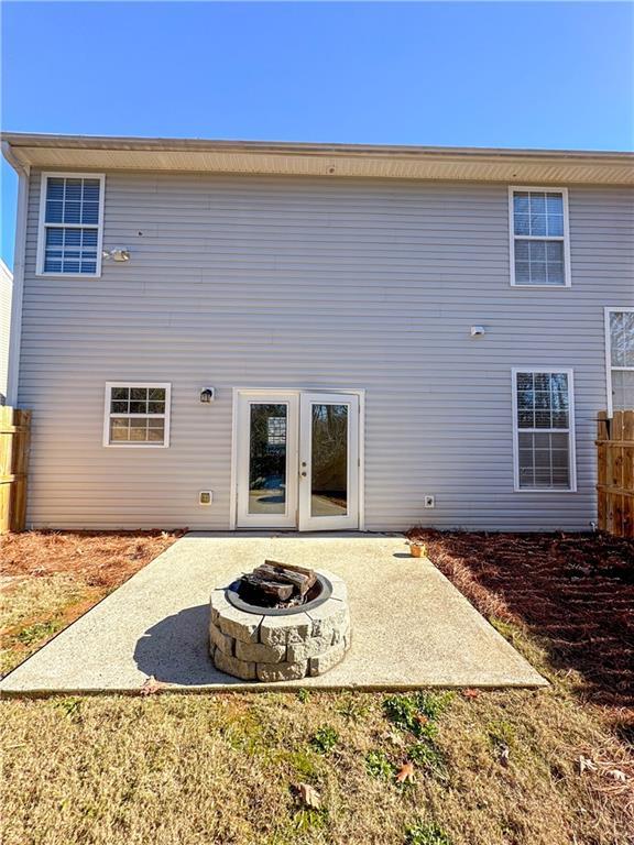 rear view of house featuring an outdoor fire pit, a patio, and french doors