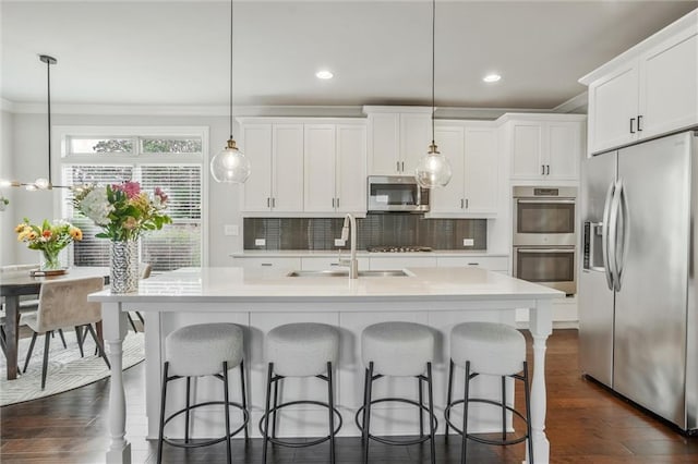 1055 Peyton View Ct, Alpharetta, GA 30004 - kitchen with appliances with stainless steel finishes, ornamental molding, a sink, light countertops, and decorative backsplash