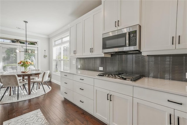 1055 Peyton View Ct, Alpharetta, GA 30004 - kitchen featuring stainless steel appliances, light countertops, dark wood finished floors, crown molding, and white cabinets