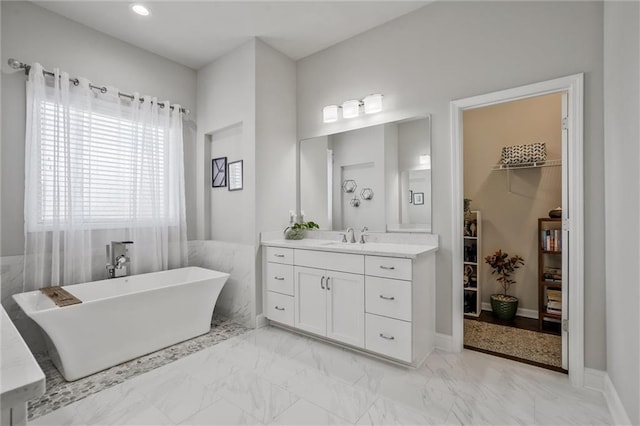 1055 Peyton View Ct, Alpharetta, GA 30004 - full bath with marble finish floors, a soaking tub, vanity, a walk in closet, and recessed lighting