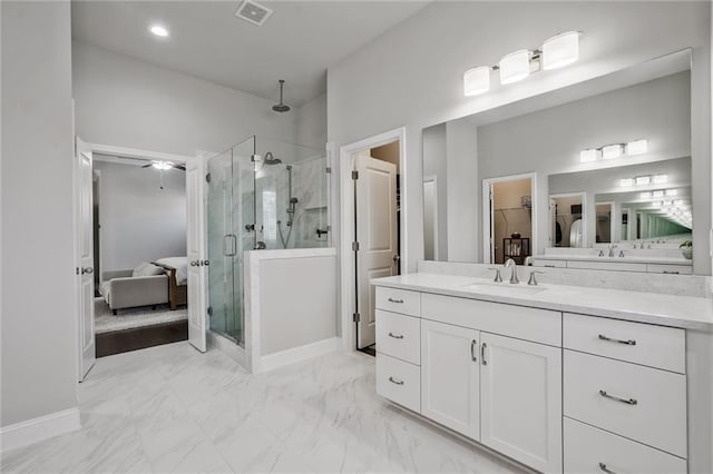 1055 Peyton View Ct, Alpharetta, GA 30004 - bathroom with a shower stall, vanity, connected bathroom, marble look tile flooring, and a walk in closet