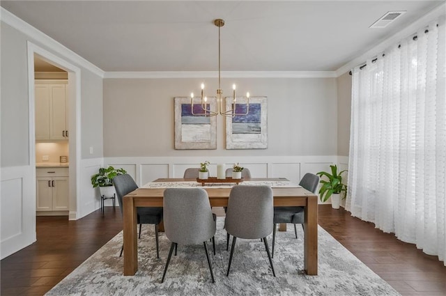 1055 Peyton View Ct, Alpharetta, GA 30004 - dining area with a chandelier, dark wood finished floors, crown molding, wainscoting, and a decorative wall