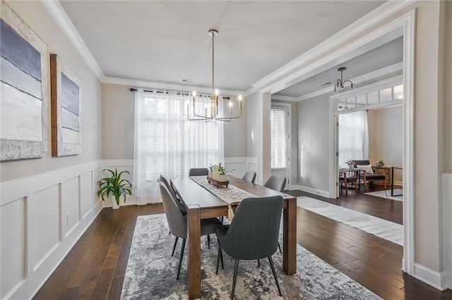 1055 Peyton View Ct, Alpharetta, GA 30004 - dining space featuring a chandelier, a wainscoted wall, dark wood-type flooring, crown molding, and a decorative wall