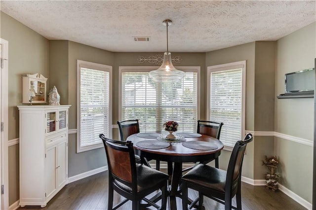 3370 Battlement Cir, Loganville, GA 30052 - dining space with dark wood-style floors and a textured ceiling