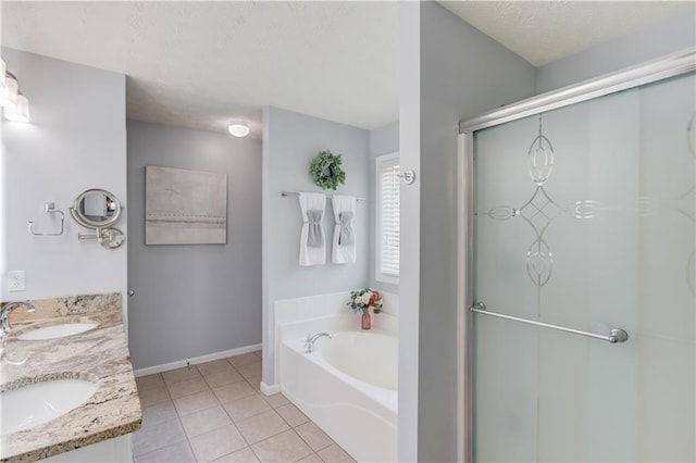 3370 Battlement Cir, Loganville, GA 30052 - full bath featuring double vanity, a bath, tile patterned floors, a shower stall, and a textured ceiling