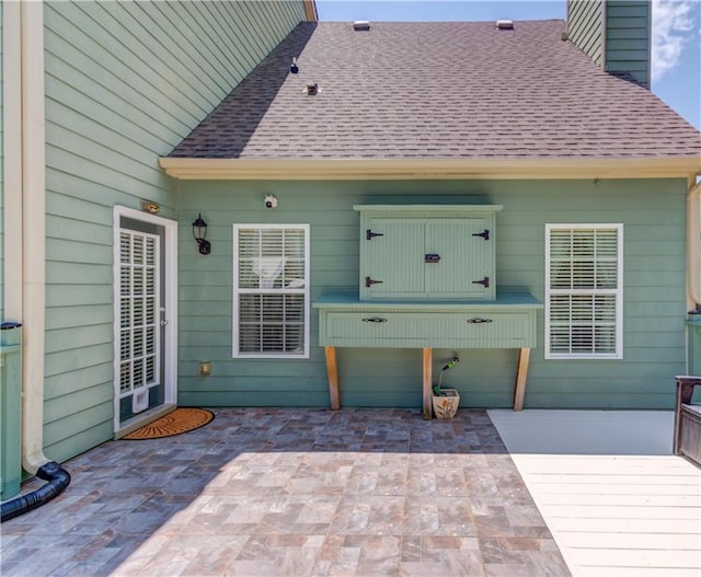 3370 Battlement Cir, Loganville, GA 30052 - back of house featuring a shingled roof, a chimney, and a patio