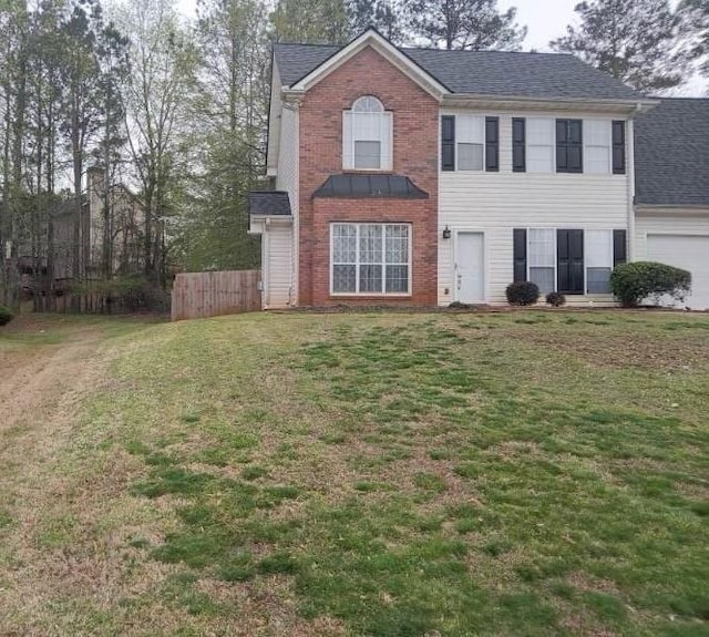 view of front of property featuring a garage and a front lawn