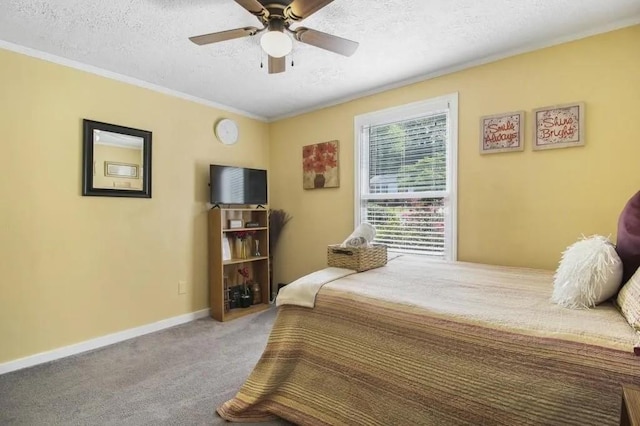 bedroom with ceiling fan, carpet floors, and a textured ceiling