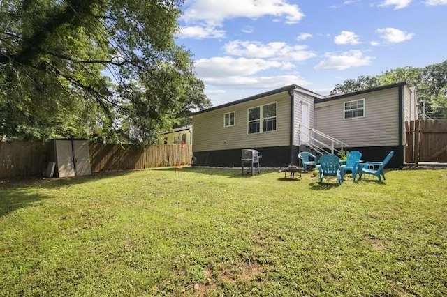 rear view of property with a yard