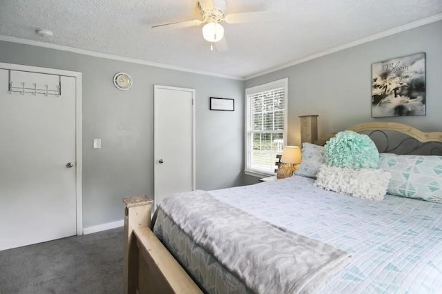 bedroom featuring dark carpet, ornamental molding, ceiling fan, and a textured ceiling