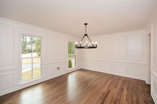 805 Wesley Oak Rd, Sandy Springs, GA 30328 - unfurnished dining area with a decorative wall, a chandelier, plenty of natural light, dark wood finished floors, and ornamental molding