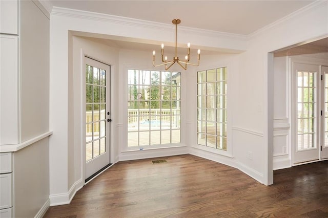 805 Wesley Oak Rd, Sandy Springs, GA 30328 - unfurnished dining area featuring a chandelier, healthy amount of natural light, dark wood-style flooring, and crown molding