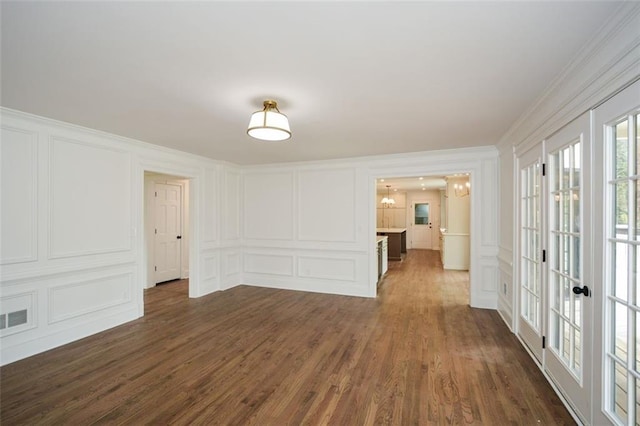 805 Wesley Oak Rd, Sandy Springs, GA 30328 - unfurnished room featuring a decorative wall, dark wood-type flooring, ornamental molding, and french doors