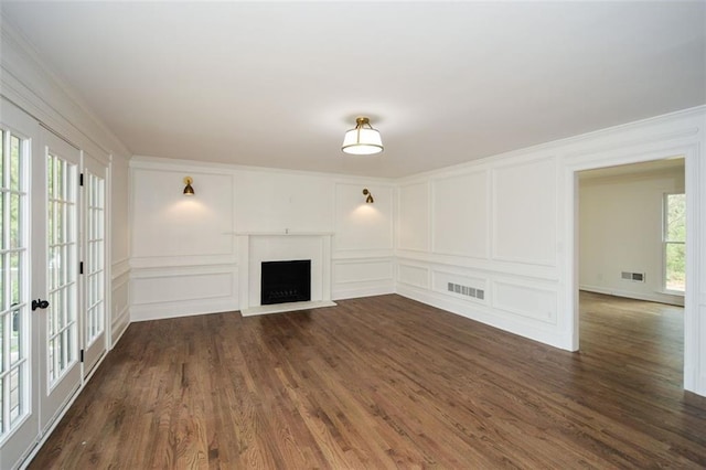 805 Wesley Oak Rd, Sandy Springs, GA 30328 - unfurnished living room with a decorative wall, dark wood-style flooring, a fireplace, ornamental molding, and french doors