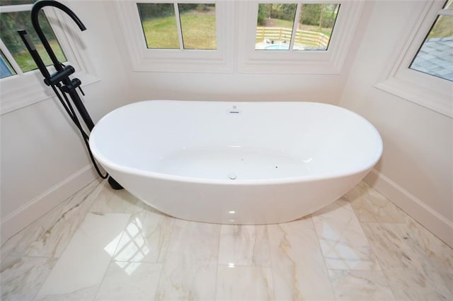 805 Wesley Oak Rd, Sandy Springs, GA 30328 - bathroom view of baseboards and a freestanding tub
