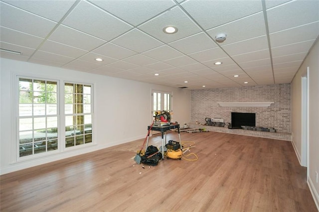 805 Wesley Oak Rd, Sandy Springs, GA 30328 - unfurnished living room with wood finished floors, a drop ceiling, a brick fireplace, and recessed lighting