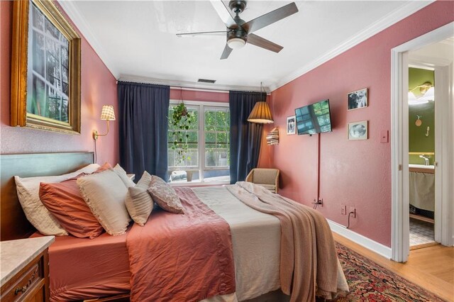 bedroom with visible vents, a ceiling fan, wood finished floors, crown molding, and baseboards