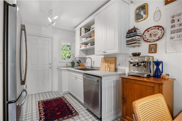 kitchen featuring open shelves, a sink, light countertops, white cabinets, and appliances with stainless steel finishes