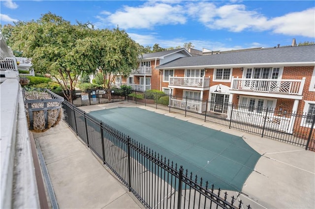 view of swimming pool with fence