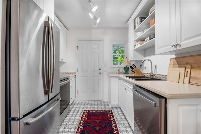 kitchen with a sink, open shelves, light countertops, and stainless steel appliances