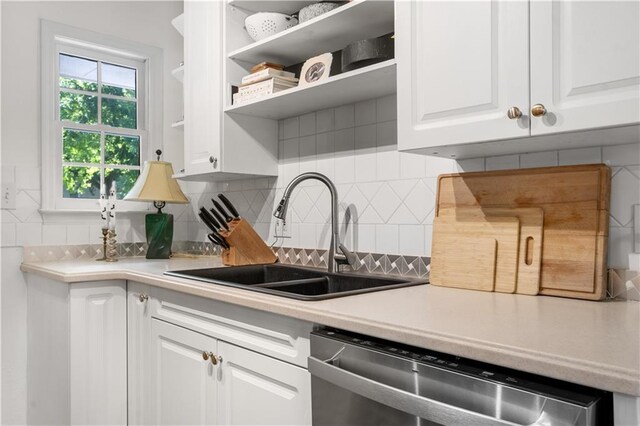 kitchen featuring a sink, open shelves, white cabinetry, light countertops, and dishwasher