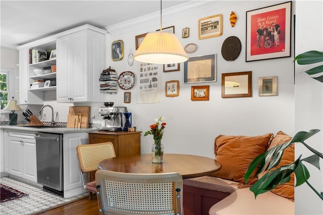 dining space featuring breakfast area, dark wood-type flooring, and ornamental molding