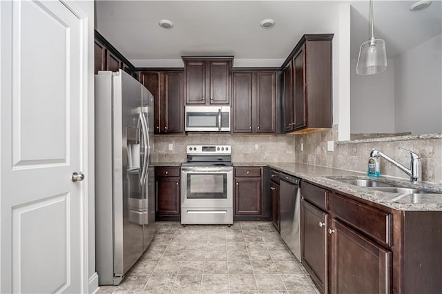 2544 Castellan Dr, Atlanta, GA 30316 - kitchen featuring stainless steel appliances, a sink, light stone countertops, dark brown cabinetry, and tasteful backsplash