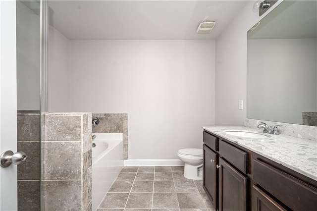 2544 Castellan Dr, Atlanta, GA 30316 - bathroom with toilet, vanity, a garden tub, baseboards, and tile patterned flooring