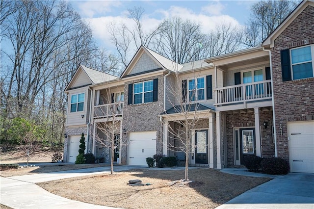 2544 Castellan Dr, Atlanta, GA 30316 - view of front of property featuring a balcony, an attached garage, driveway, and brick siding