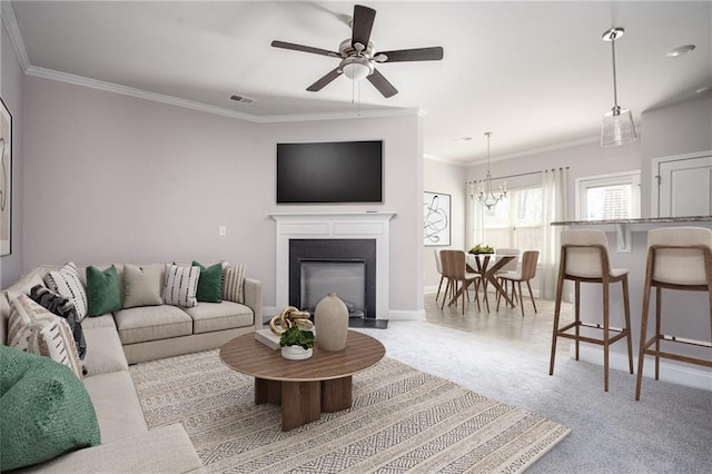 2544 Castellan Dr, Atlanta, GA 30316 - living room featuring crown molding, a ceiling fan, a chandelier, a glass covered fireplace, and baseboards
