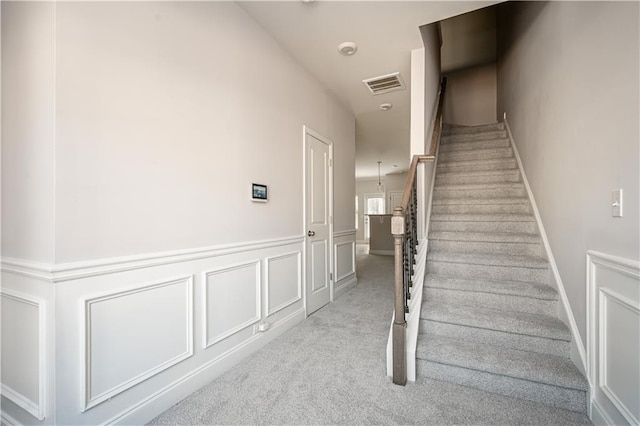 2544 Castellan Dr, Atlanta, GA 30316 - staircase with carpet flooring and wainscoting