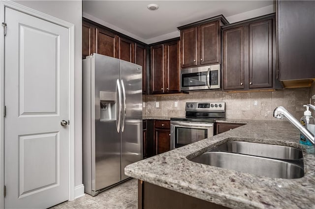 2544 Castellan Dr, Atlanta, GA 30316 - kitchen featuring stainless steel appliances, a sink, dark brown cabinetry, and tasteful backsplash
